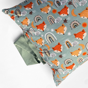 little earth tribe pregnancy & feeding pillow with orange foxes on sage background with sage ribbon